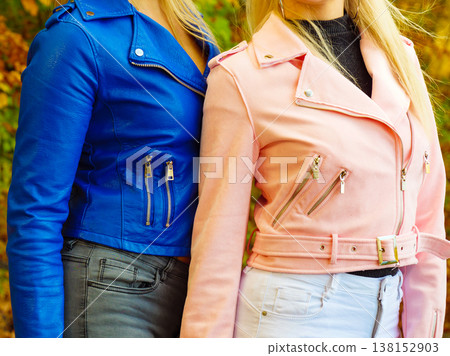 Two women walking in autumn park 138152903