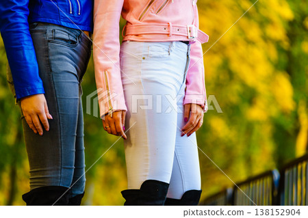 Two women wearing blue and white tight jeans Two women wearing blue and white tight jeans 138152904