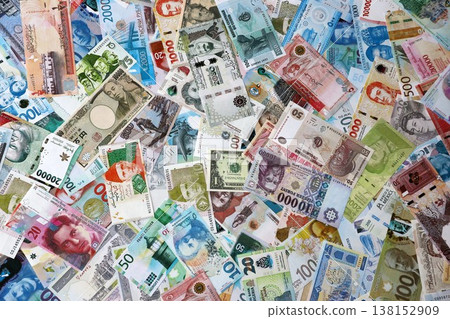 Different banknotes from many currencies of the whole world. Big pile of money bills close up Different banknotes from many currencies of the whole world. Big pile of money bills close up 138152909