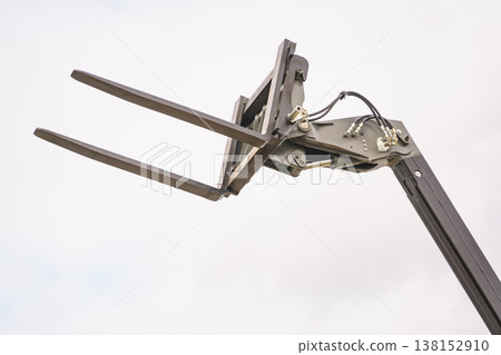 Forklift industrial loader or stacker against sky. 138152910