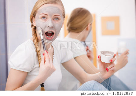 Woman with grey clay mud mask on her face Woman with grey clay mud mask on her face 138152987