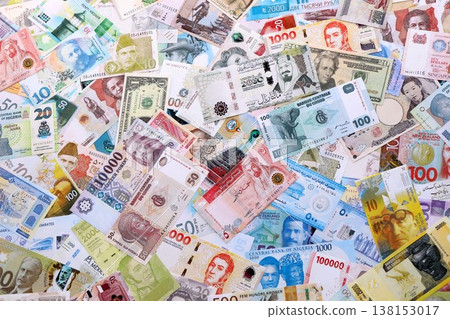Many banknotes of different currency. Background of big amount of random money bills close up. Currency Exchange concept 138153017