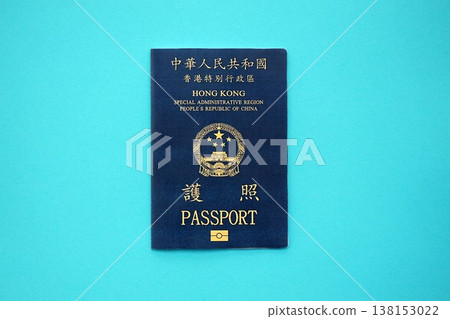 Hong Kong Special Administrative Region HKSAR Passport lies on blue table background close up. Hong Kong blue new passport book in details 138153022