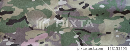 Texture of dark green and grey military camouflage fabric as texture for army uniform parts, hunter or fisherman clothes. Khaki camo texture close up Texture of dark green and grey military camouflage fabric as texture for army uniform parts, hunter or fisherman clothes. Khaki camo texture close up 138153393