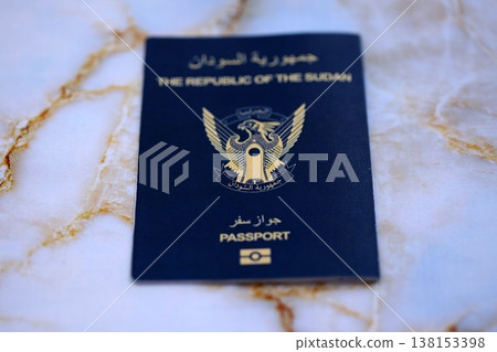 Sudanese passport on table close up. Official identification document book for citizens of Sudan. Concept of travel and tourism Sudanese passport on table close up. Official identification document book for citizens of Sudan. Concept of travel and tourism 138153398