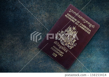 Cambodian passport on table close up. Official identification document book for citizens of Cambodia. Concept of travel and tourism in Cambodia Cambodian passport on table close up. Official identification document book for citizens of Cambodia. Concept of travel and tourism in Cambodia 138153414