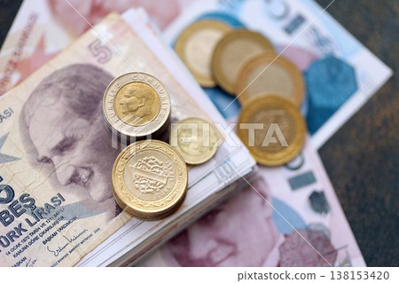 Turkish lira money bills and kurus coins pile on table. Turkey coins on banknotes of TRY currency close up. Concept of business, taxes and banking in Turkey 138153420