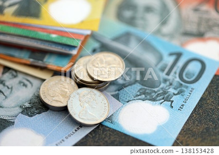 Australian dollar money bills and cent coins pile on table. Australia coins on banknotes of AUD currency close up. Concept of business, taxes and banking in Australia Australian dollar money bills and cent coins pile on table. Australia coins on banknotes of AUD currency close up. Concept of business, taxes and banking in Australia 138153428