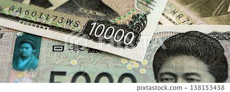 Japanese yen money bills pile on table. Japan banknotes of JPY currency close up. Concept of business, economy and banking in Japan 138153438