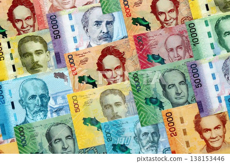 Costa Rican old and new colon money bills pile on table. Costa Rica banknotes of CRC currency close up. Concept of business, economy and banking in Costa Rica Costa Rican old and new colon money bills pile on table. Costa Rica banknotes of CRC currency close up. Concept of business, economy and banking in Costa Rica 138153446