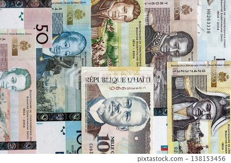 Haitian gourde money bills pile on table. Haiti banknotes of HTG currency close up. Concept of business, economy and banking in Haiti 138153456