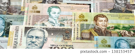 Haitian gourde money bills pile on table. Haiti banknotes of HTG currency close up. Concept of business, economy and banking in Haiti Haitian gourde money bills pile on table. Haiti banknotes of HTG currency close up. Concept of business, economy and banking in Haiti 138153457