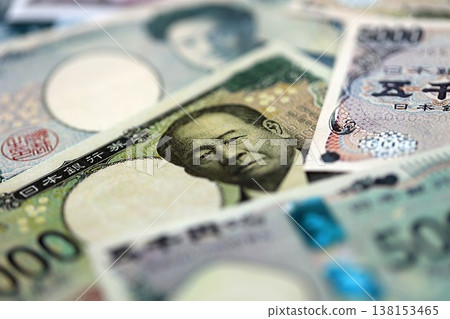 Japanese yen money bills pile on table. Japan banknotes of JPY currency close up. Concept of business, economy and banking in Japan 138153465