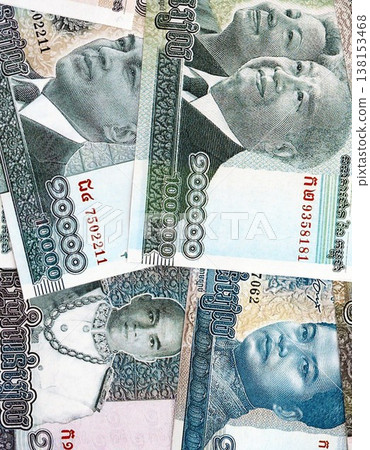 Cambodian riel money bills pile on table. Cambodia banknotes of KHR currency close up. Concept of business, economy and banking in Cambodia Cambodian riel money bills pile on table. Cambodia banknotes of KHR currency close up. Concept of business, economy and banking in Cambodia 138153468