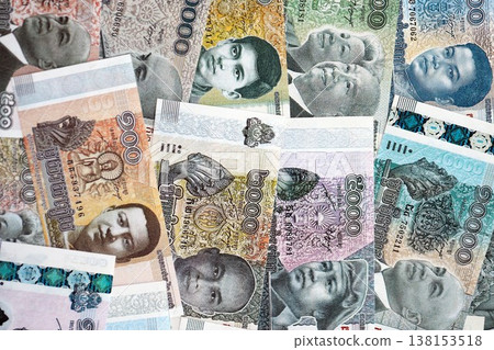 Cambodian riel money bills pile on table. Cambodia banknotes of KHR currency close up. Concept of business, economy and banking in Cambodia Cambodian riel money bills pile on table. Cambodia banknotes of KHR currency close up. Concept of business, economy and banking in Cambodia 138153518