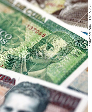 Cuban peso money bills pile on table. Cuba banknotes of CUP currency close up. Concept of business, economy and banking in Cuba Cuban peso money bills pile on table. Cuba banknotes of CUP currency close up. Concept of business, economy and banking in Cuba 138153523