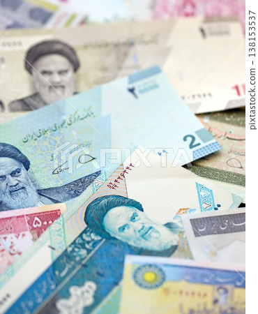 Iranian rial money bills pile on table. Iran banknotes of IRR currency close up. Concept of business, economy and banking in Iran Iranian rial money bills pile on table. Iran banknotes of IRR currency close up. Concept of business, economy and banking in Iran 138153537