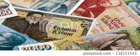 Icelandic krona money bills pile on table. Iceland banknotes of ISK currency close up. Concept of business, economy and banking in Iceland Icelandic krona money bills pile on table. Iceland banknotes of ISK currency close up. Concept of business, economy and banking in Iceland 138153543
