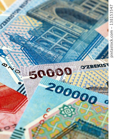 Uzbek som money bills pile on table. Uzbekistan banknotes of UZN currency close up. Concept of business, economy and banking in Uzbekistan 138153547