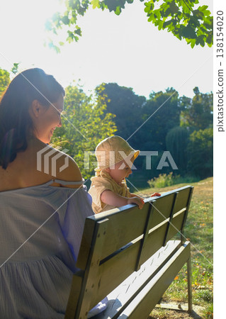 Mother and Child Enjoying a Sunny Day in the Park 138154020