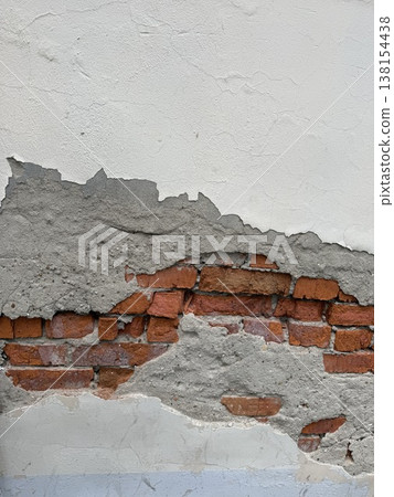 Peeling plaster reveals brick wall detail, ideal for textured backgrounds or construction concepts Peeling plaster reveals brick wall detail, ideal for textured backgrounds or construction concepts 138154438