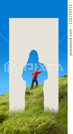 Woman walking through human silhouette paper cutout in grassy hill landscape. Woman walking through human silhouette paper cutout in grassy hill landscape. 138154552