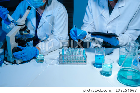 scientist researcher conducting an experiment working in the chemical laboratory. scientist researcher conducting an experiment working in the chemical laboratory. 138154668