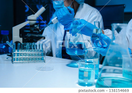 Scientist mixing chemical liquids in the chemistry lab. Scientist mixing chemical liquids in the chemistry lab. 138154669
