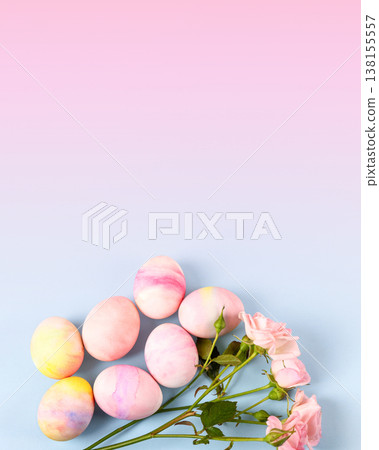 Pale pink Easter eggs with a sprig of pink roses on a pink blue gradient background. Happy Easter concept. Greeting card, copy space Pale pink Easter eggs with a sprig of pink roses on a pink blue gradient background. Happy Easter concept. Greeting card, copy space 138155557