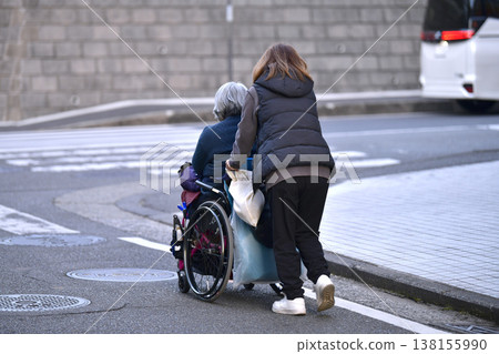 Yokohama cityscape in Japan: Steps and unevenness... Aging society: Elderly woman in wheelchair (no markings) has a hard time pushing... = Yokohama city Yokohama cityscape in Japan: Steps and unevenness... Aging society: Elderly woman in wheelchair (no markings) has a hard time pushing... = Yokohama city 138155990