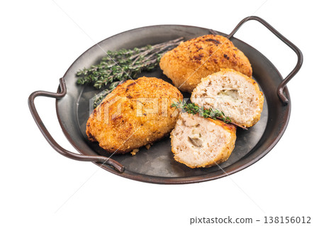Breaded chicken cutlet stuffed chicken with butter filling served in skillet with garlic and thyme on isolated background Breaded chicken cutlet stuffed chicken with butter filling served in skillet with garlic and thyme on isolated background 138156012