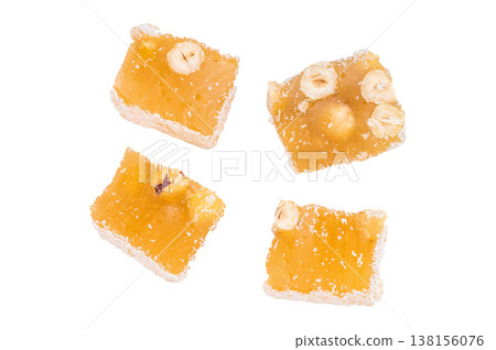 Turkish delight with hazelnut pieces and coconut flakes. Soft chewy candy photographed from above with copy space. Turkish delight with hazelnut pieces and coconut flakes. Soft chewy candy photographed from above with copy space. 138156076