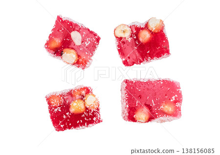 Turkish delight lokum cubes with hazelnuts and almonds coated in coconut flakes. Sweet jelly candy isolated on white background.. 138156085