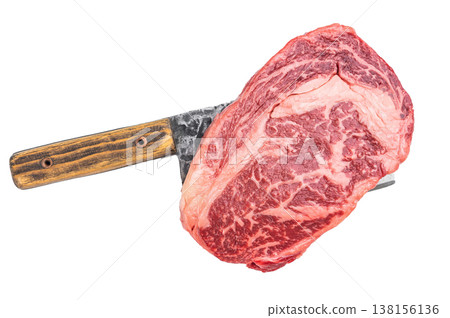 Raw marbled ribeye beef steak with rich fat texture and herbs isolated on light stone background. Fresh uncooked meat with copy space. Raw marbled ribeye beef steak with rich fat texture and herbs isolated on light stone background. Fresh uncooked meat with copy space. 138156136