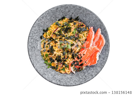 Spicy noodle bowl with imitation crab sesame and nori on isolated backdrop modern Asian cuisine dish Spicy noodle bowl with imitation crab sesame and nori on isolated backdrop modern Asian cuisine dish 138156148