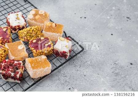 Premium assorted lokum sweets on cooling rack. Soft chewy jelly candy for holidays and gift concepts. Premium assorted lokum sweets on cooling rack. Soft chewy jelly candy for holidays and gift concepts. 138156216