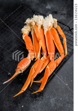 Cooked king red kamchatka crab legs on metal rack over dark background premium seafood with copy space for menu design Cooked king red kamchatka crab legs on metal rack over dark background premium seafood with copy space for menu design 138156223