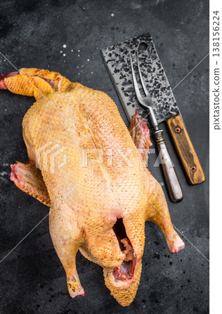 Wild duck game carcass from hunting on dark studio background. Fresh raw poultry meat for cooking rustic and seasonal cuisine. Wild duck game carcass from hunting on dark studio background. Fresh raw poultry meat for cooking rustic and seasonal cuisine. 138156224