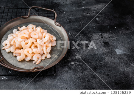 Small prawns in vintage pan on black background, seafood cooking ingredient with copy space for restaurant and food branding. Small prawns in vintage pan on black background, seafood cooking ingredient with copy space for restaurant and food branding. 138156229