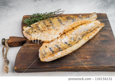 Roasted zander fillets, also known as walleye or pike perch, seasoned with herbs and served rustic style. Roasted zander fillets, also known as walleye or pike perch, seasoned with herbs and served rustic style. 138156232