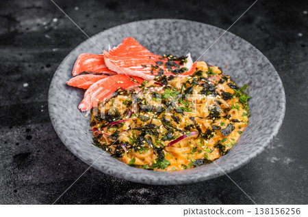 Bowl of spicy seafood ramen noodles with crab sticks nori and sesame on dark background Asian comfort food top view Bowl of spicy seafood ramen noodles with crab sticks nori and sesame on dark background Asian comfort food top view 138156256