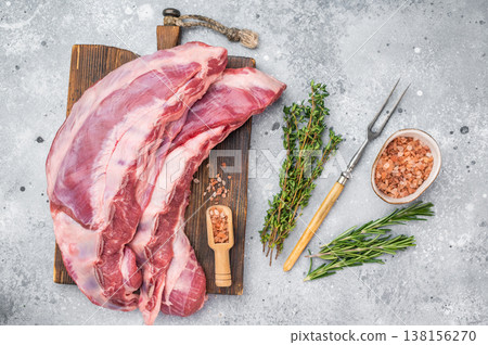 Uncooked lamb belly breast cut with rosemary thyme and salt on wooden board light background butcher style preparation with copy space Uncooked lamb belly breast cut with rosemary thyme and salt on wooden board light background butcher style preparation with copy space 138156270