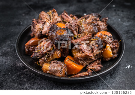 Homemade beef and lamb oxtail ragout in skillet, gelatin rich slow cooked meat with vegetables, overhead food photography 138156285