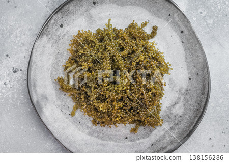 Sea grapes also known as green caviar and sea caviar served on ceramic plate over light gray background Japanese umibudo Sea grapes also known as green caviar and sea caviar served on ceramic plate over light gray background Japanese umibudo 138156286