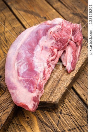 Raw lamb meat breast with herbs and garlic on rustic wooden table fatty cut ingredient for bbq roasting and braising Raw lamb meat breast with herbs and garlic on rustic wooden table fatty cut ingredient for bbq roasting and braising 138156291
