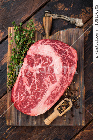 Raw Entrecote ribeye beef steak with strong marbling, rib eye cut for grilling roasting or bbq, premium fresh meat on wooden background Raw Entrecote ribeye beef steak with strong marbling, rib eye cut for grilling roasting or bbq, premium fresh meat on wooden background 138156305