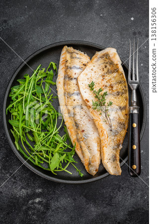 Cooked zander fillets, also known as walleye or pike perch, seared and plated with greens. Cooked zander fillets, also known as walleye or pike perch, seared and plated with greens. 138156306