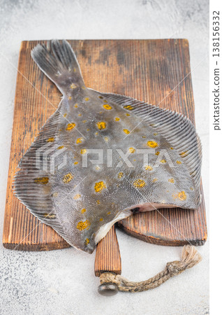 Raw fluke flatfish seafood on wooden board with thyme and pepper fresh marine fish ingredient Raw fluke flatfish seafood on wooden board with thyme and pepper fresh marine fish ingredient 138156332