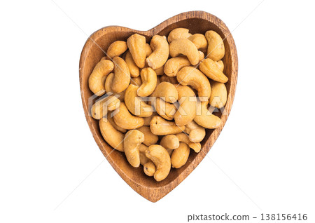 Cashew nuts in a wooden bowl on a clean white background creating a bright minimal ingredient Cashew nuts in a wooden bowl on a clean white background creating a bright minimal ingredient 138156416