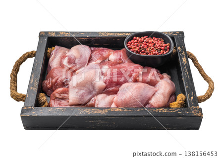 Raw quail breast fillets and pink peppercorns in a vintage black wooden crate. Fresh game meat for gourmet cooking. Raw quail breast fillets and pink peppercorns in a vintage black wooden crate. Fresh game meat for gourmet cooking. 138156453